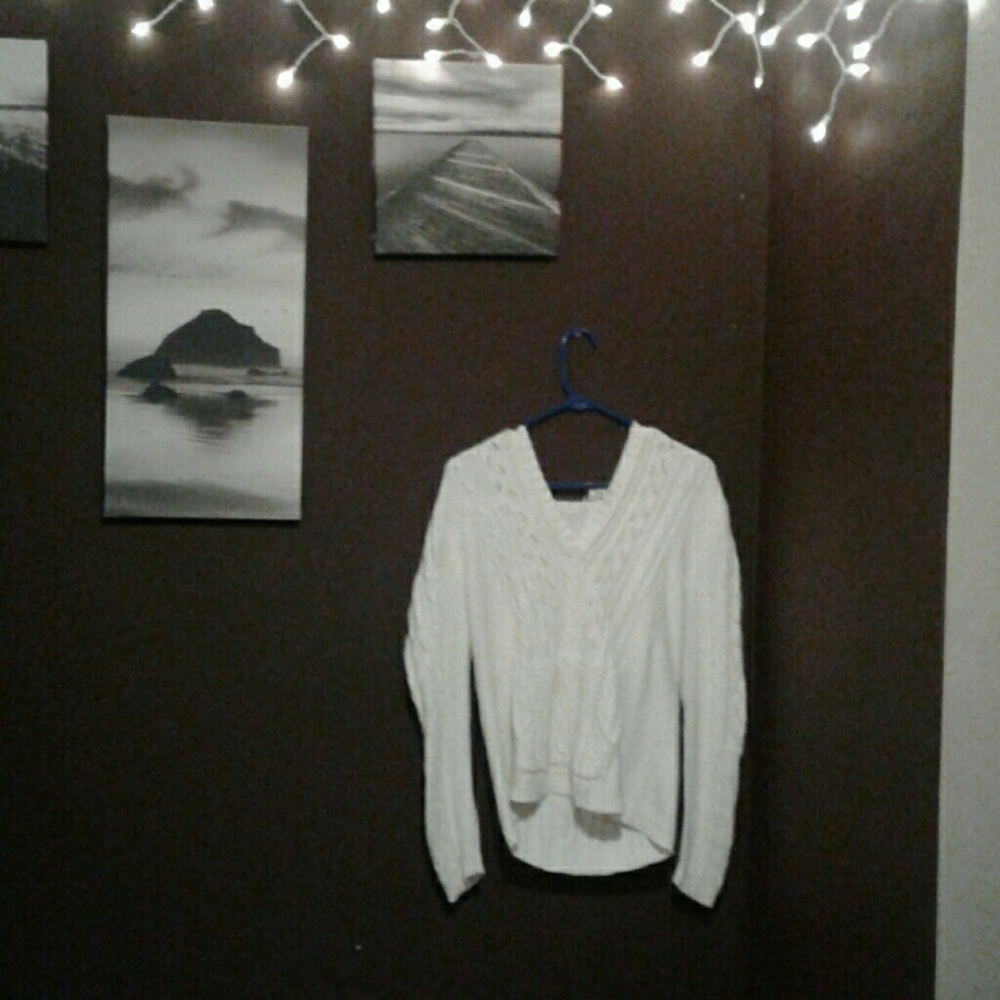 White sweater that is knitted